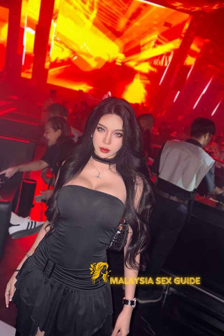 Attractive woman in a black dress at a KL nightclub.