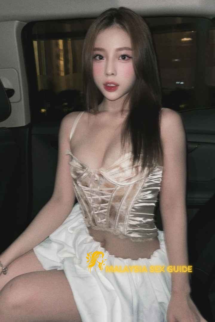Attractive woman in a corset and skirt. Malaysia sex guide.