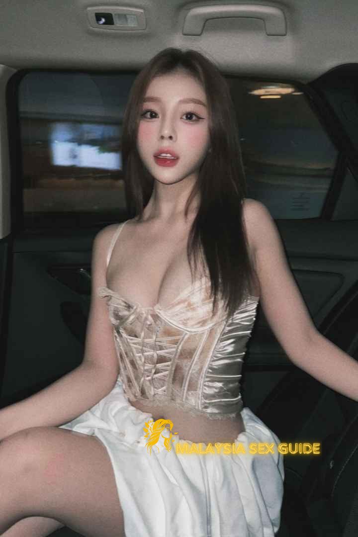 Attractive woman in a beige corset and white skirt. Malaysia Sex Guide.