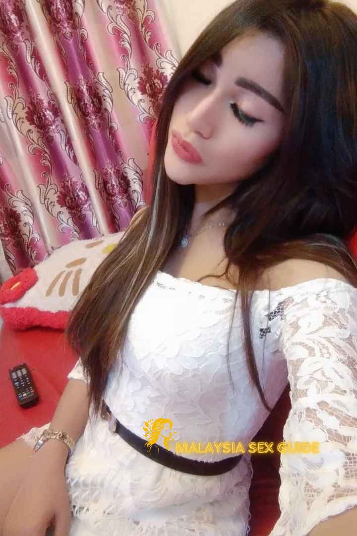 Attractive KL escort girl in a white lace dress.