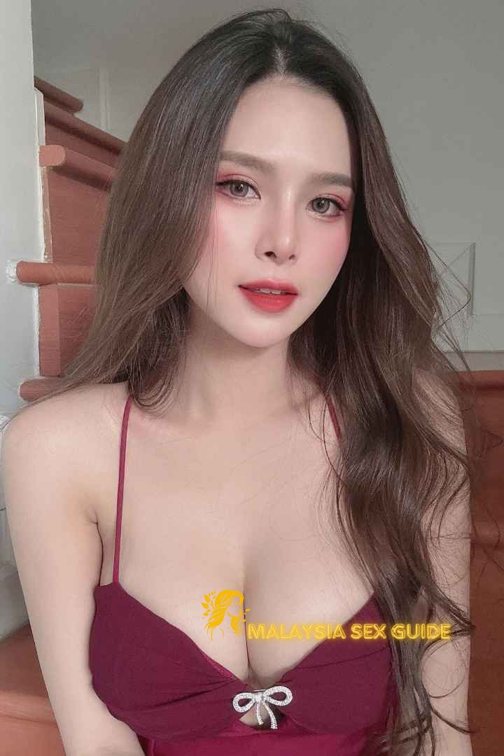 Attractive young woman in a burgundy dress.