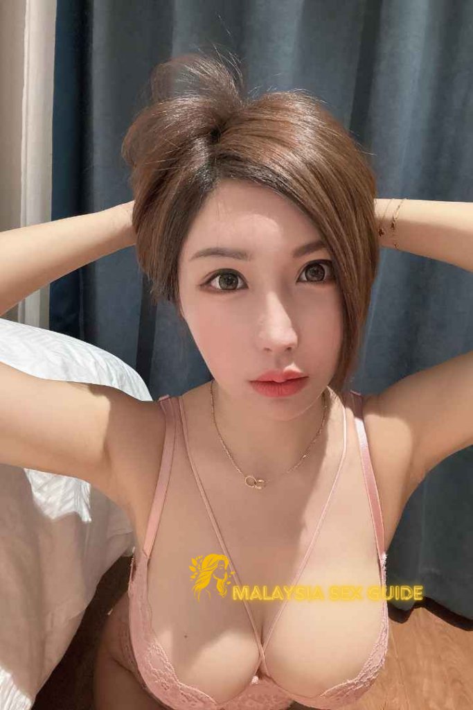 Attractive young woman in a pink bra. Malaysia Sex Guide.