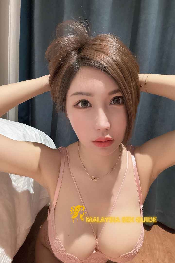 Attractive young woman in a pink bra. Malaysia Sex Guide.