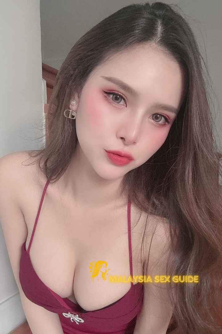 Attractive young woman in a red dress. KL Girl Service.