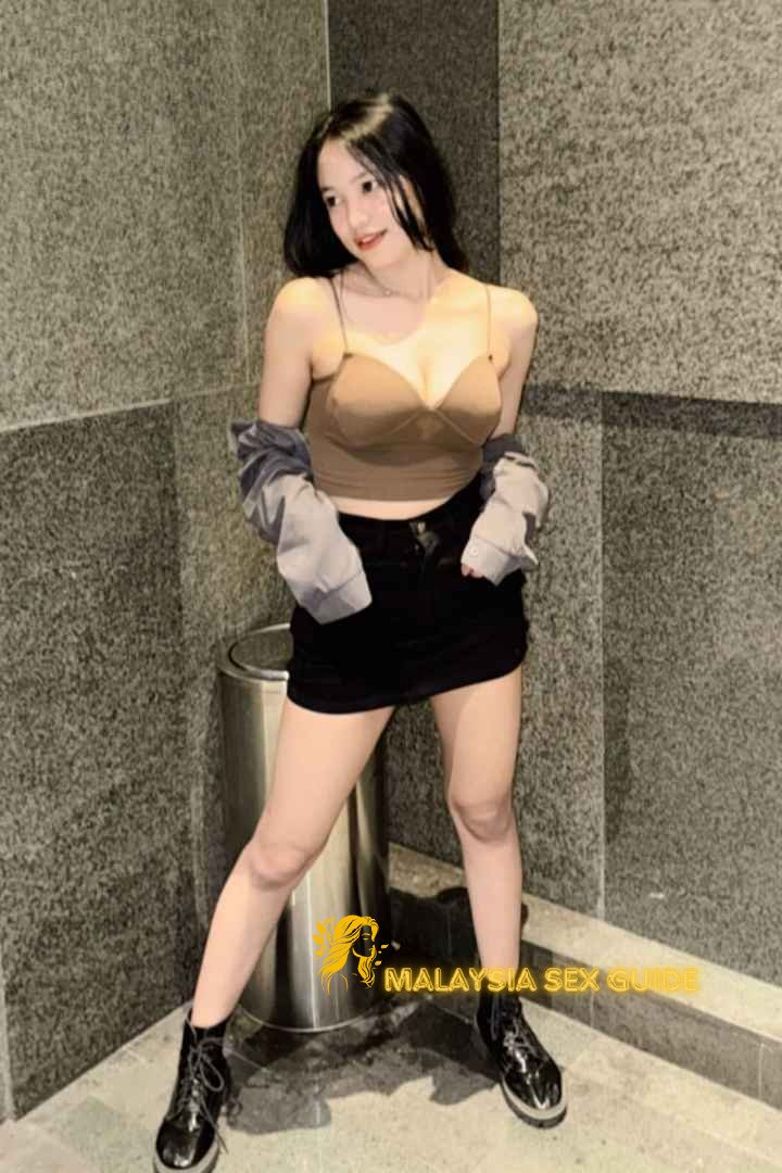 Young woman in brown top and black skirt in Kuala Lumpur.