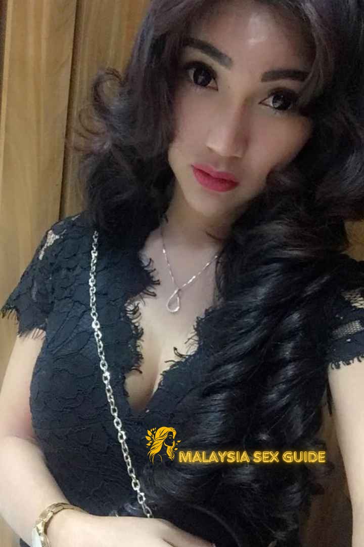 Attractive KL escort girl in a black lace dress.