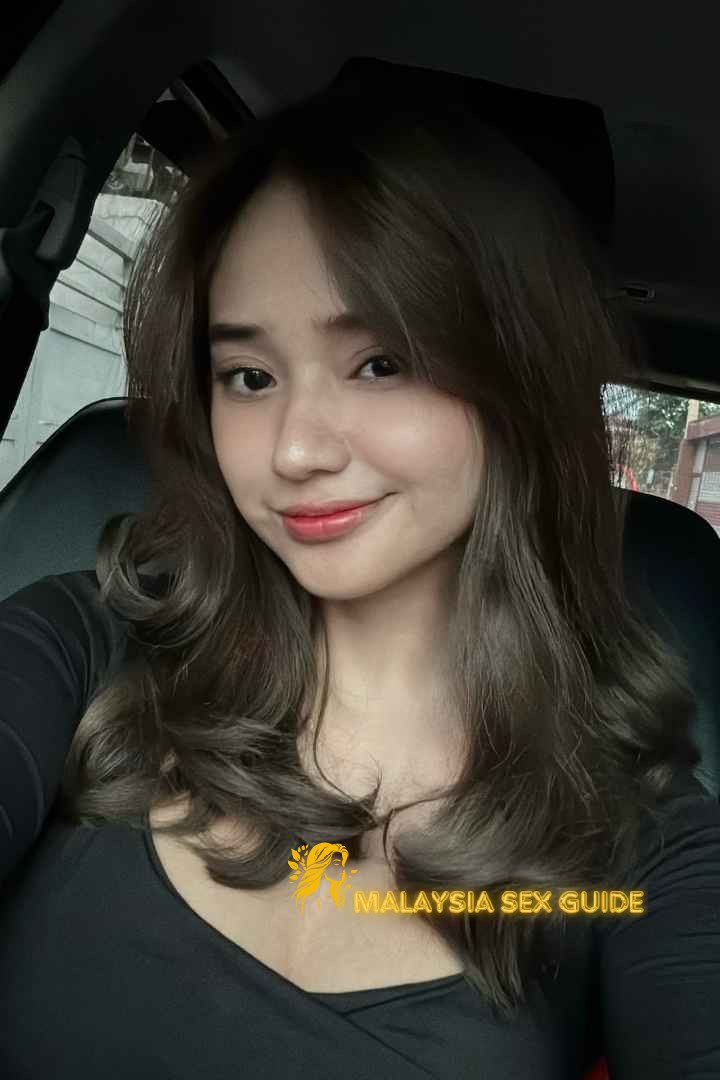 Attractive young woman in a car, KL Escort Outcall.