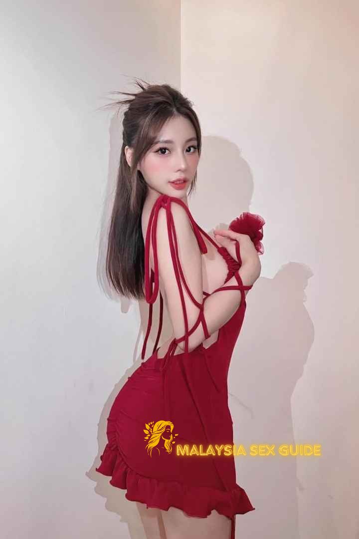 Attractive woman in a red dress. Malaysia sex guide.