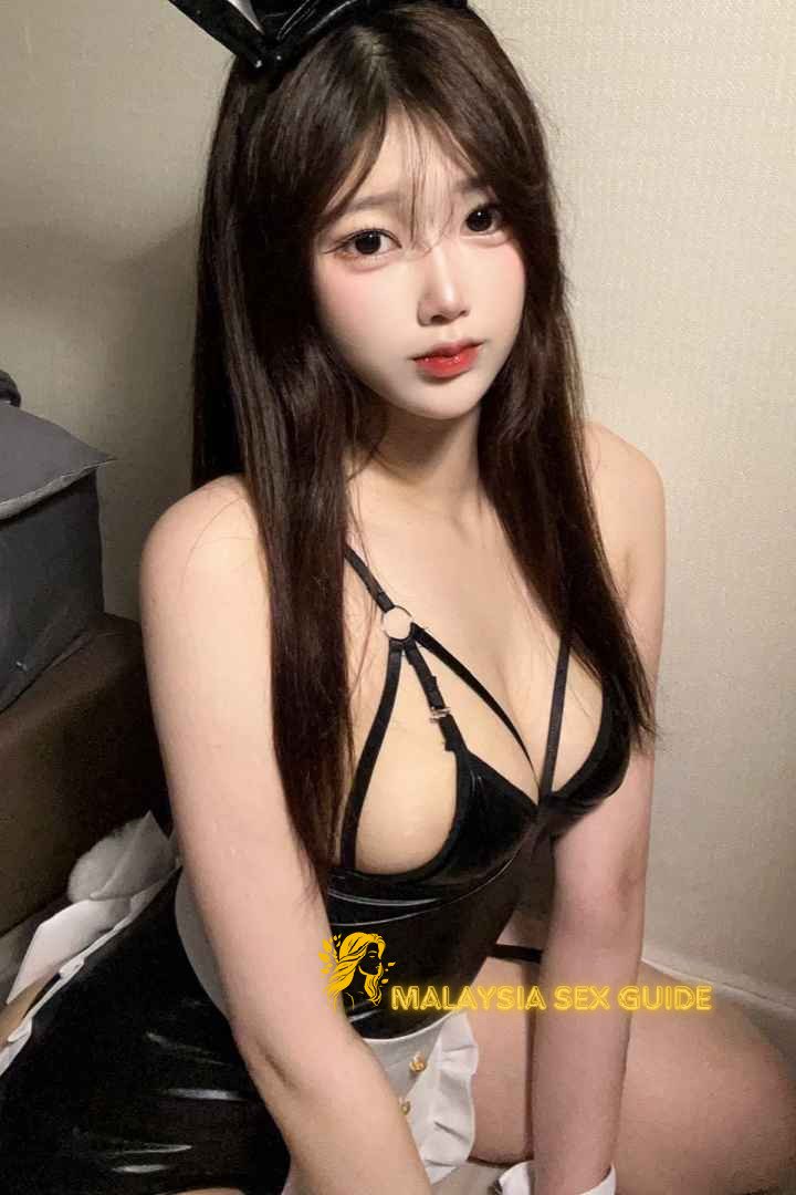 Attractive young woman in a black bunny girl costume.