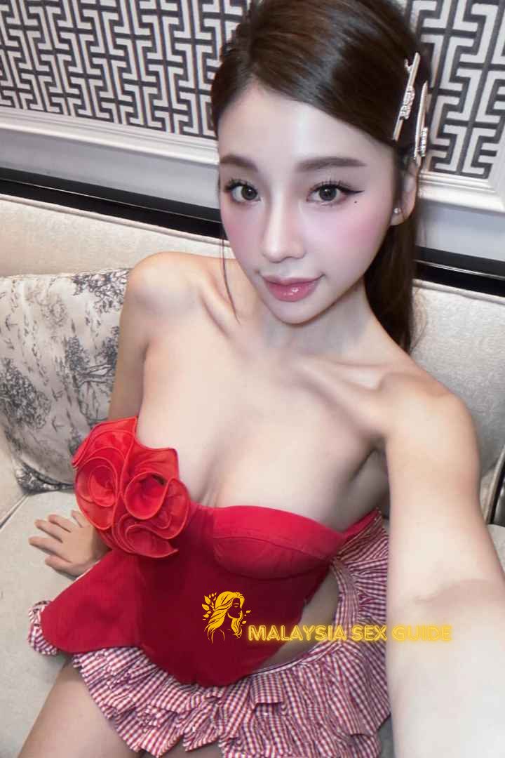 Attractive woman in red corset and gingham skirt. Malaysia sex guide.