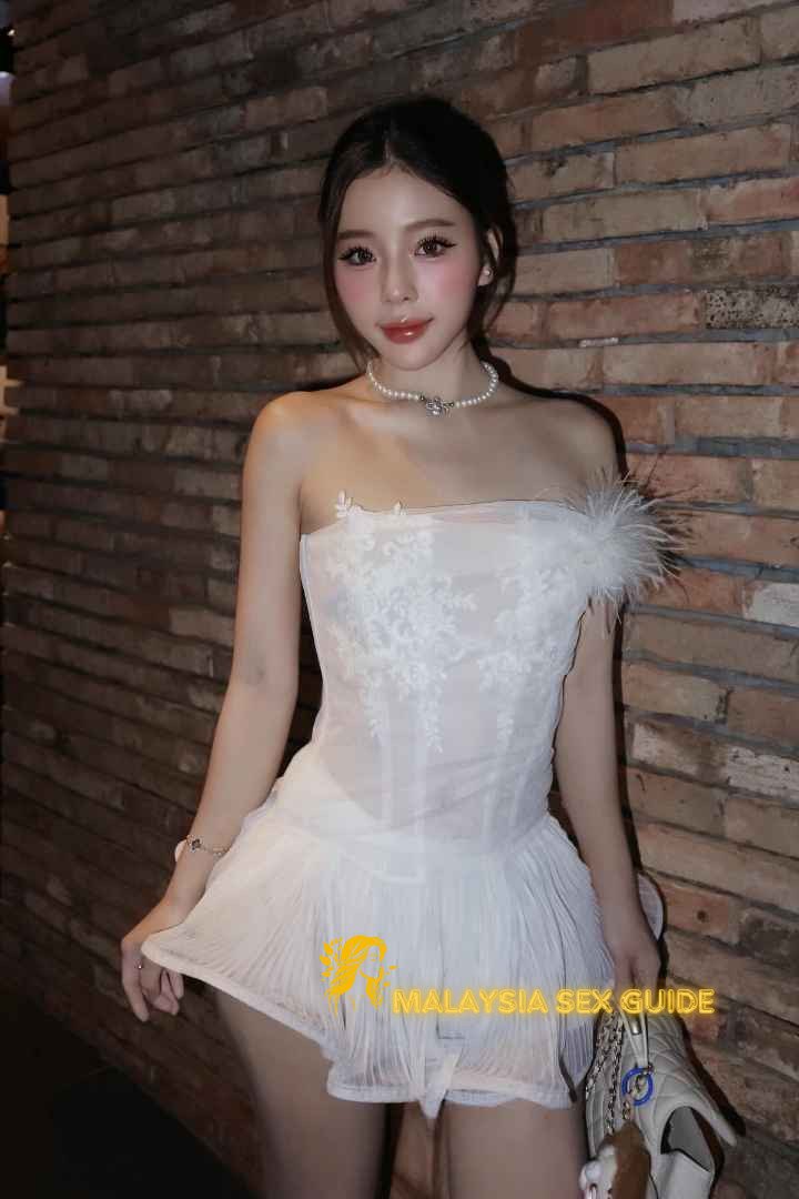 Attractive woman in a white corset dress. Malaysia sex guide.