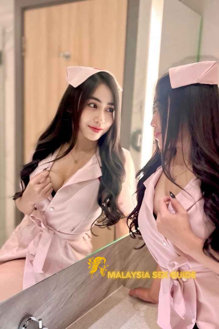 Attractive Malay woman in a pink nurse's uniform