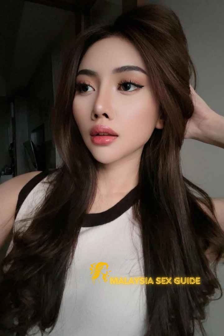 Attractive Malay woman with long brown hair.
