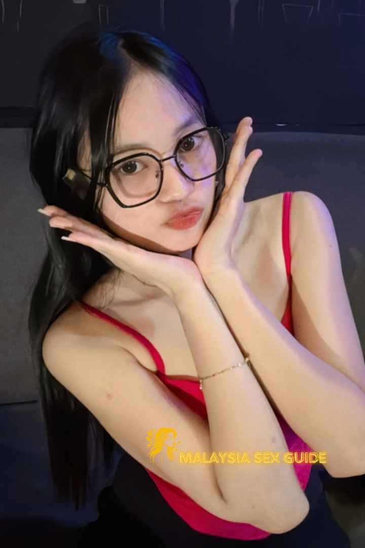 Attractive young woman in red top, Kuala Lumpur.
