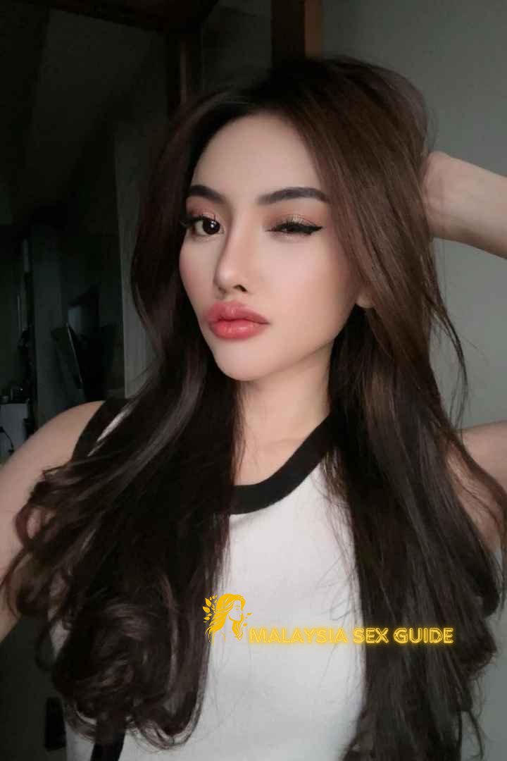 Attractive Malay woman with long dark hair.