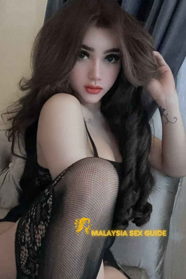 Attractive KL escort girl in black lingerie and stockings.