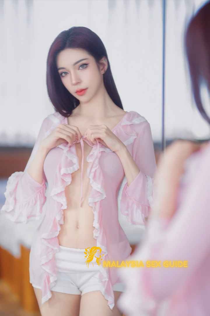 Attractive woman in pink robe and white shorts.