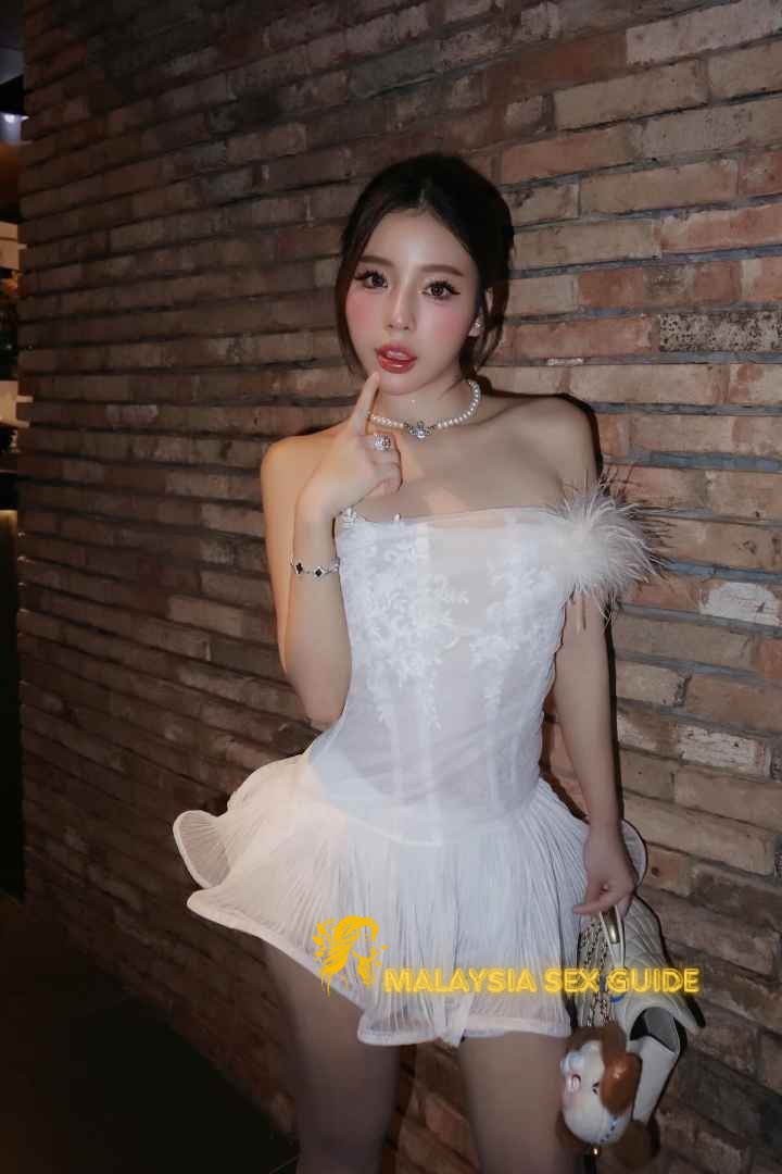 Woman in elegant white dress, Malaysia sex guide