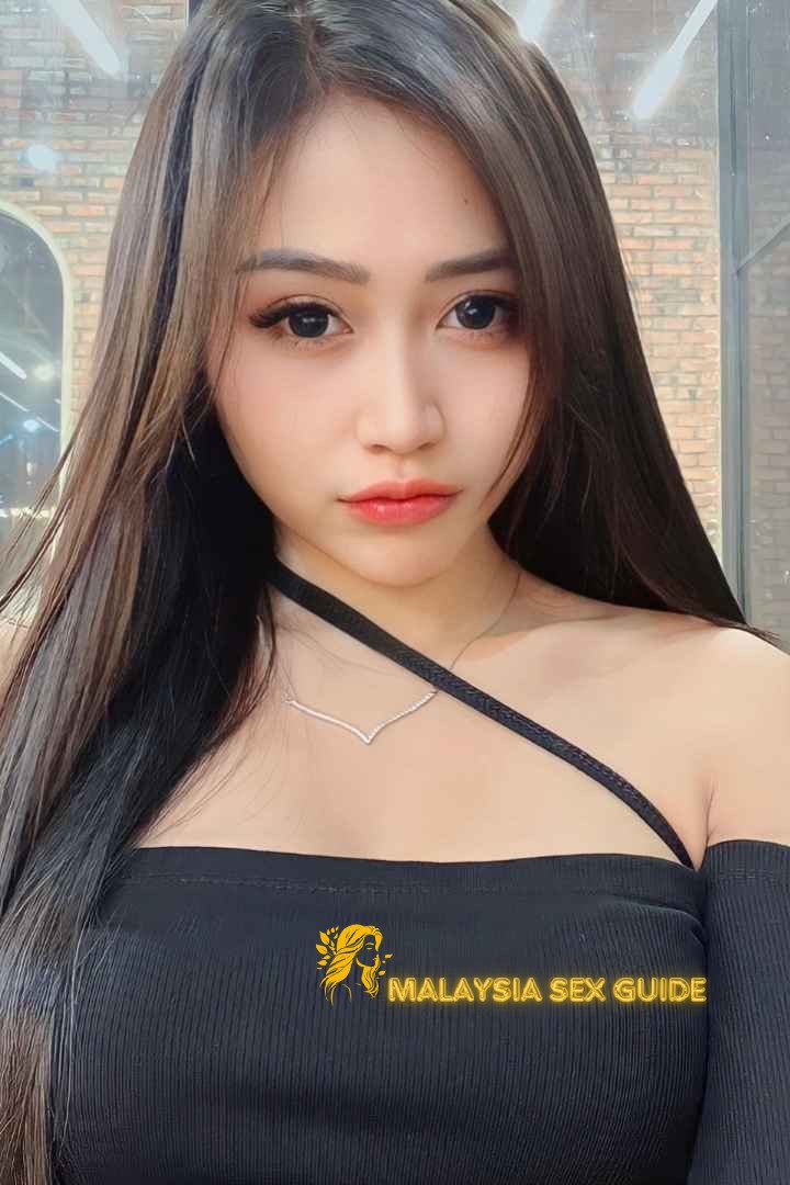 Attractive Malay woman wearing a black top.