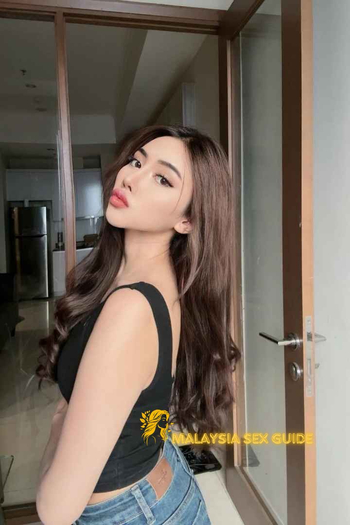 Attractive Malay woman in jeans and black top. Malaysia escort.